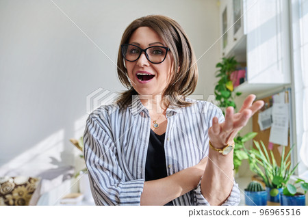 Webcam view of positive mature woman making video call at home 96965516