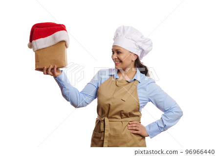Isolated portrait on white background, multi-ethnic waitress bartender, baker confectioner in chef's apron, holding takeaway food and drink packed in a paper bag with Santa hat. Delivery at Christmas Isolated portrait on white background, multi-ethnic waitress bartender, baker confectioner in chef's apron, holding takeaway food and drink packed in a paper bag with Santa hat. Delivery at Christmas 96966440