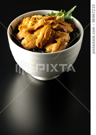 Raw sea urchin bowl with perilla and wasabi on a black background 96967210