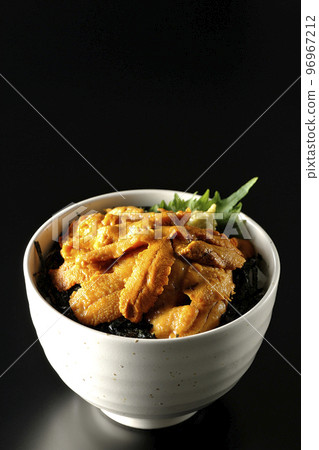 Raw sea urchin bowl with perilla and wasabi on a black background Raw sea urchin bowl with perilla and wasabi on a black background 96967212
