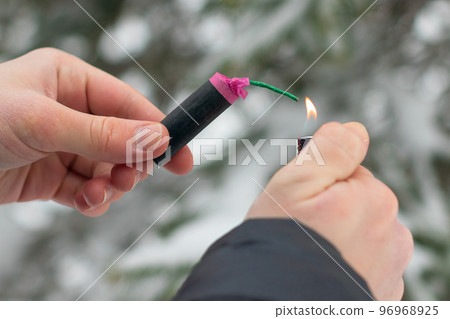 Guy Sets Fire to the Flash Noise Firecracker Outdoors 96968925