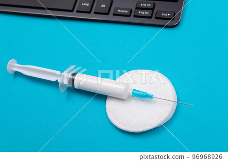 Vaccination or Revaccination Concept - A Medical Syringe on Blue Table 96968926