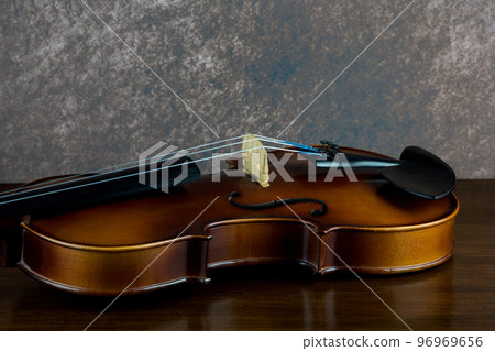 Violin Lying on a Polished Wooden Surface Closeup Violin Lying on a Polished Wooden Surface Closeup 96969656