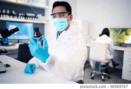 Covid, scientist and man with bottle in laboratory with cure or cough mixture. Science, research and male developing chemical, medicine or treatment, remedy or medication for flu, corona or covid 19. 96969767