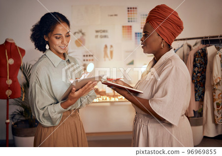 Fashion design, tablet and collaboration at night with designer women planning and talking ideas for creative project. Female entrepreneur and partner with technology in small business for marketing Fashion design, tablet and collaboration at night with designer women planning and talking ideas for creative project. Female entrepreneur and partner with technology in small business for marketing 96969855