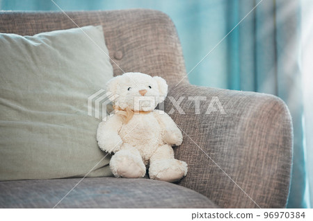 Lonely, loss and adoption with a teddy bear abandoned on a sofa in an empty living room of a home. Lost, alone and grief with a stuffed animal sitting on a couch in the lounge of a house alone Lonely, loss and adoption with a teddy bear abandoned on a sofa in an empty living room of a home. Lost, alone and grief with a stuffed animal sitting on a couch in the lounge of a house alone 96970384