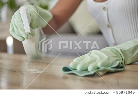 Woman, spray bottle and sanitizer cleaning with a cleaner wiping a table surface with a cloth or rag in the home. Hands, spraying and disinfectant with a female clean bacteria and house work on desk Woman, spray bottle and sanitizer cleaning with a cleaner wiping a table surface with a cloth or rag in the home. Hands, spraying and disinfectant with a female clean bacteria and house work on desk 96971049