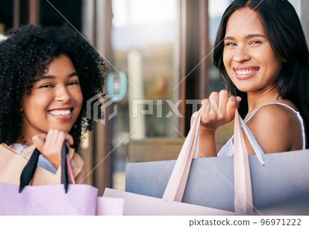 Friends, face and luxury shopping, bags and outdoor retail store, shopping mall and happy with discount or promotion. Wealthy women, happiness and customer portrait with shopping bad and product 96971222