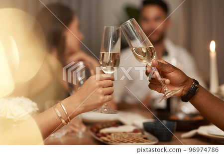 Closeup, champagne and glasses for celebration, party or friends enjoy New Years dinner or drinks together. Hands, toast and alcohol for drinking, event and food for social gathering, cheers or relax Closeup, champagne and glasses for celebration, party or friends enjoy New Years dinner or drinks together. Hands, toast and alcohol for drinking, event and food for social gathering, cheers or relax 96974786