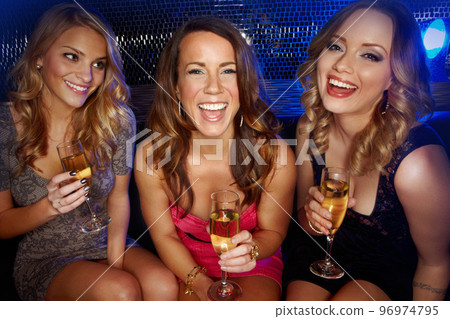 Friends, champagne and party portrait in nightclub to celebrate birthday, new years or social event. Smile, happiness and women friendship celebration with drink, disco or happy reunion in club 96974795