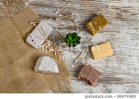 Top view bath and spa accesspries and houseplant. Craft soaps and salt rock. Bamboo ear sticks. 96974969