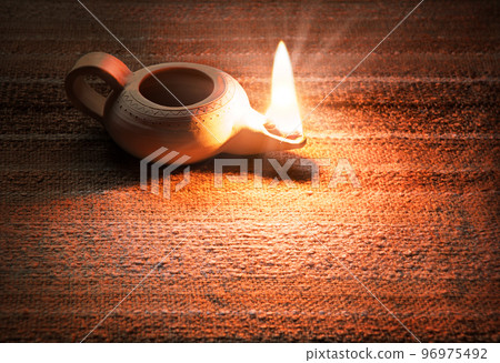 Ancient lamp shines in the dark 96975492