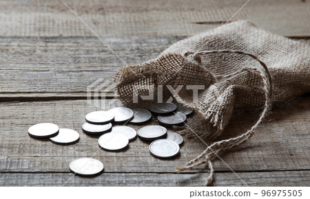 Thirty coins in a bag on the table 96975505