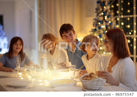 Christmas dinner. Family with kids at Xmas tree. 96975547