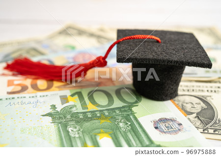 Graduation gap hat on Euro and US dollar banknotes money, Education study fee learning teach concept. 96975888