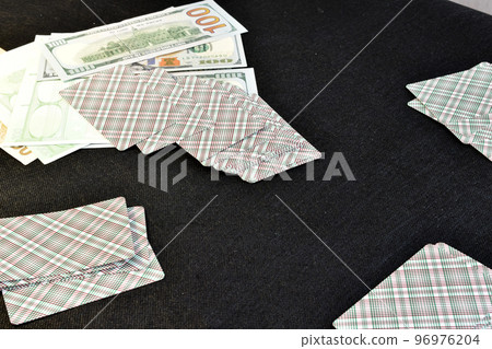 Cards dealt for four and money on the table. Cards dealt for four and money on the table. 96976204