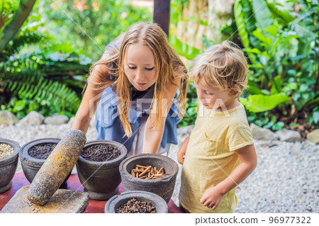 Mom and son are looking at different spices Mom and son are looking at different spices 96977322