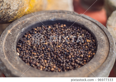 milled black pepper ,Black pepper corns In a large pot 96977333