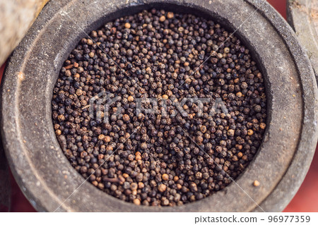 milled black pepper ,Black pepper corns In a large pot 96977359