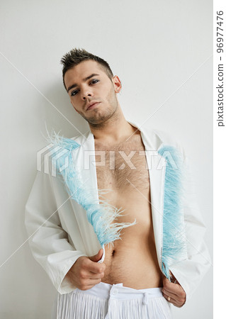 Mon binary man wearing makeup and extravagant outfit 96977476