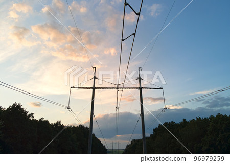 Dark silhouette of high voltage tower with electric power lines at sunrise. Dark silhouette of high voltage tower with electric power lines at sunrise. 96979259