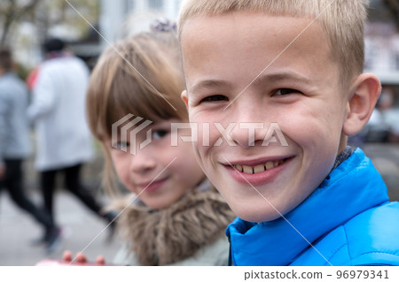 Closeup portrait of two children boy and girl tofether outdoors. 96979341