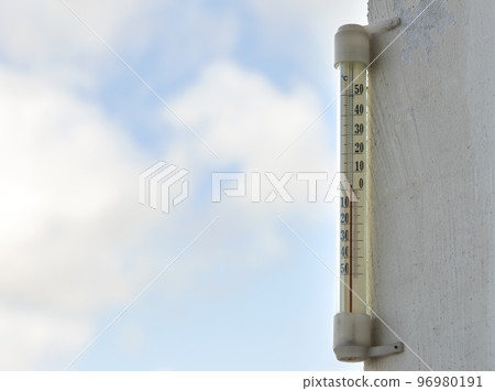 Alcohol glass thermometer Celsius outside on bright blurred light outdoors copy space background. Alcohol glass thermometer Celsius outside on bright blurred light outdoors copy space background. 96980191