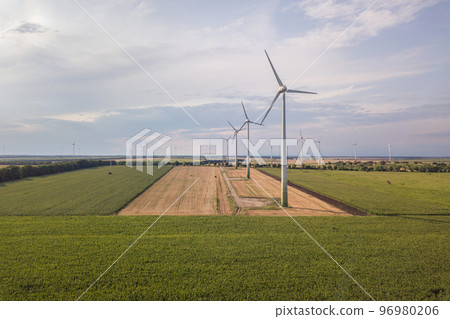 Aerial view of wind turbine generators in field producing clean ecological electricity. Aerial view of wind turbine generators in field producing clean ecological electricity. 96980206