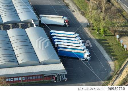 Aerial view of goods warehouses and logistics center in industrial city zone from above Aerial view of goods warehouses and logistics center in industrial city zone from above 96980730