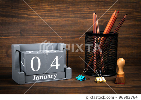 4 January inscription on wooden calendar. Wooden office desk 96982764