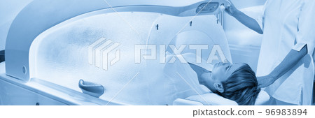 Modern spa treatment capsule in cosmetology clinic, cosmetologist operating equipment Modern spa treatment capsule in cosmetology clinic, cosmetologist operating equipment 96983894