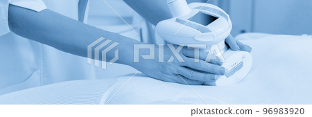 Woman in special white suit getting anti cellulite massage in a spa salon. LPG, and body contouring treatment in clinic. Woman in special white suit getting anti cellulite massage in a spa salon. LPG, and body contouring treatment in clinic. 96983920