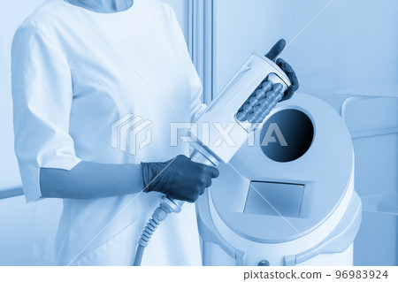 cosmetologist standing in rubber gloves doing endospheres therapy 96983924