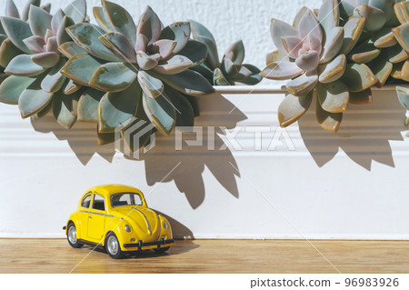 Travel car concept. Toy yellow car moves on against the backdrop of nature. Driving, adventure, discovery idea 96983926