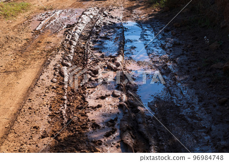 Mud and puddles on the dirt road Mud and puddles on the dirt road 96984748