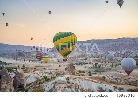 Colorful hot air balloon flying over Cappadocia, Turkey 96985016