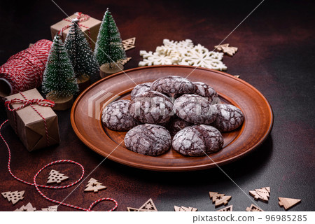 Delicious fresh brownies with Christmas decorations on a dark concrete background Delicious fresh brownies with Christmas decorations on a dark concrete background 96985285