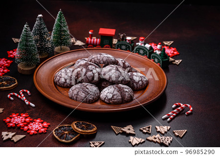 Delicious fresh brownies with Christmas decorations on a dark concrete background 96985290