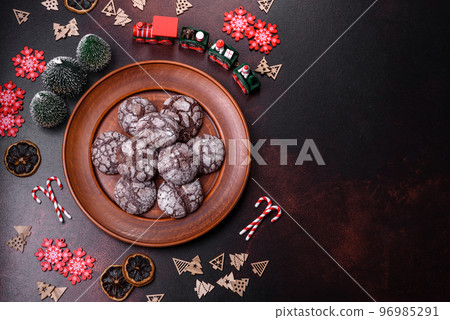 Delicious fresh brownies with Christmas decorations on a dark concrete background Delicious fresh brownies with Christmas decorations on a dark concrete background 96985291