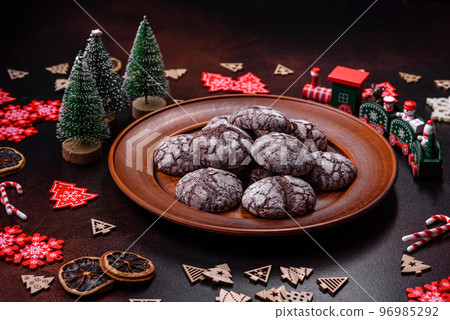 Delicious fresh brownies with Christmas decorations on a dark concrete background Delicious fresh brownies with Christmas decorations on a dark concrete background 96985292