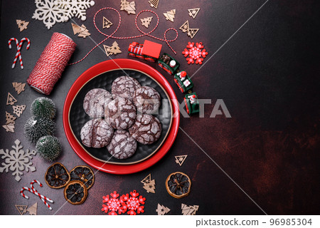 Delicious fresh brownies with Christmas decorations on a dark concrete background 96985304