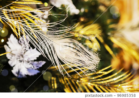 Christmas decoration, feather, balls, blurred garland bokeh and snowflakes, abstract background Christmas decoration, feather, balls, blurred garland bokeh and snowflakes, abstract background 96985358
