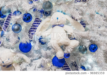 Christmas tree decoration in form of fluffy rabbit toy, glittering balls. Merry Christmas, Happy New Year of rabbit Christmas tree decoration in form of fluffy rabbit toy, glittering balls. Merry Christmas, Happy New Year of rabbit 96985359