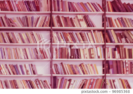 Abstract blurred background of bookshelves with books, trendy monochrome color. Concept of learning, education Abstract blurred background of bookshelves with books, trendy monochrome color. Concept of learning, education 96985368