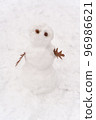Funny snowman standing in the winter forest 96986621