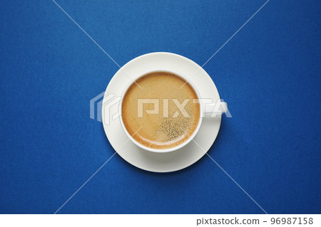 Classic black coffee on blue background, top view. Color of the year 2020 Classic black coffee on blue background, top view. Color of the year 2020 96987158