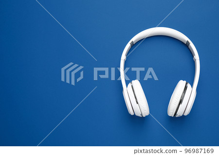 Headphones on bright background, top view with space for text. Color of the year 2020 (Classic blue) Headphones on bright background, top view with space for text. Color of the year 2020 (Classic blue) 96987169