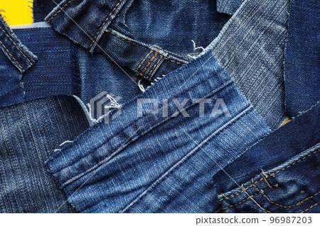 Many patches of old jeans on yellow background, top view 96987203