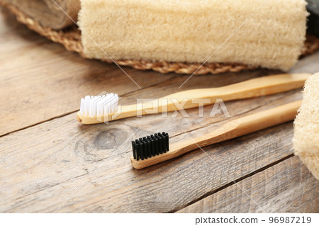 Toothbrushes made of bamboo on wooden table 96987219