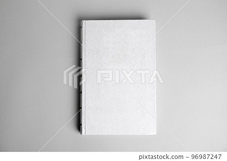 Hardcover book on light grey background, top view. Space for design 96987247